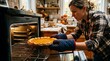 © Gabriel Bayer - Woman placing a pumpkin pie into a warm oven for baking