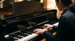 © Bane - Man playing grand piano in a dimly lit room for artistic performance