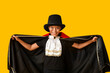 © Pixel-Shot - Cute happy African-American boy dressed as Dracula for Halloween party on yellow background
