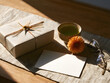 © Naiem - Wrapped gift box with a cup of tea and a blank greeting card on a wooden table in sunlight