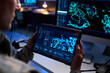 © pressmaster - Caucasian male soldier holding tablet with digital map in high tech control room, analyzing tactical data. Image suitable for defense technology and cybersecurity marketing, close up shot