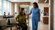 © Christina - Caring nurse assisting a patient stand up from a waiting room chair in clinic