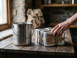 © VISUAL BACKGROUND - Organizing canned food rations and metal pot on wooden desk