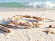 © PARMAR - Beach theme cowrie shell and natural bead macrame rakhi on white sand