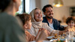 © Olha Havelia - candid documentary-style photo, concept family, extended family sharing a festive meal at a home table for Eid, children in new modest clothing, warm natural window light, genuine