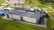 © Dark Artistic - Aerial view showing a new data center building under construction with a large crane. Steel roof framework. Cooling systems. And an electrical substation in the background