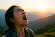 © Pixel-Shot - Asian woman screaming with mouth wide open, looking up at the sky during sunset in a mountainous landscape