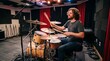 © creativestock - Musician playing drums in a recording studio with soundproofing
