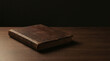 © Kadang Kesel - Weathered leather bound ledger book closed on dark wooden surface