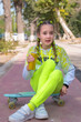 © Anna - Surprised girl with soda can sitting on skateboard. Concept: Shocking teen news, Unhealthy carbonated drinks, Autumn school break.
