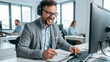 © pattozher - Customer Service Excellence: A smiling customer service representative, wearing a headset and glasses, actively engages with a client while diligently taking notes on a notepad beside his computer.