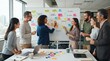 © Rizky - Diverse team brainstorming ideas on a whiteboard in a modern office meeting room.