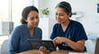 © nina - Doctor and patient discussing medical data on tablet in clinic