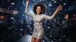 © mashimara - Joyful woman celebrating with confetti at a lively nightclub party