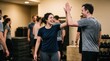 © ryker - Fitness woman man laughing high five gym workout exercise happy group, woman laughing during gym workout, giving high five to man with group training equipment in indoor fitness class