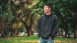 © Yevhen - Young man smiling walking in green urban park