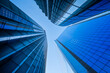 © yaqui_villegas - A wide perspective opens on sky in London's financial district, while glass planes pull the view upward and office architecture narrows around a skyscraper facade.