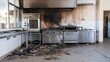 © Bonsales - Abandoned commercial kitchen showing severe fire damage, blackened walls, destroyed appliances, and debris on floor