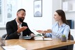 © New Africa - Businesspeople working together at wooden table in office. Team work