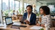 © True Stock - Two women collaborating on a transparent tablet in a modern office