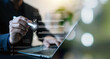 © wasan - Business professional using a laptop with digital checklist and check marks, illustrating task management, workflow, project planning, productivity, compliance, and successful task completion.