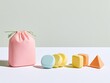 © Ananda - Pink Pouch with Colorful Geometric Shapes on White Surface.