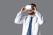 © Pixel-Shot - Male doctor in VR glasses on grey background