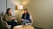 © haptic - Two colleagues talking in a quiet sensory friendly meeting room