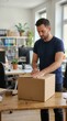 © Larysa - Carefully preparing a cardboard parcel for shipment