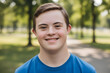© Natallia - Young man with down syndrome smiling outdoors