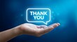 © marzan - Hand holding glowing thank you speech bubble message
