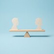 © Christella - Concept of gender equality and social parity with paper silhouettes on a balanced wooden seesaw.