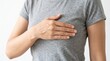 © gabrielvf - Breast Cancer Awareness: A woman's hand rests gently on her chest, symbolizing breast cancer awareness and the importance of self-care and early detection.