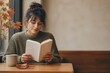 © GoshaMovies - Young woman reading book in cozy cafe