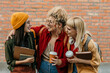 © La Famiglia - Diverse students walking, drinking coffee, and laughing outdoors