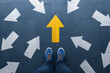 © NongEngEng - AI generated person facing bold yellow arrow among multiple white arrows representing choice direction decision making leadership focus strategy moving forward