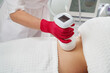 © Maria - professional cosmetologist performing radiofrequency lifting procedure on the stomach of a woman