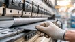 © The Little Hut - Skilled worker operates industrial press brake machine for precise metal sheet bending in manufacturing facility