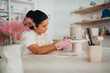 © Cavan Images - Creative hispanic woman making handmade ceramics in a studio