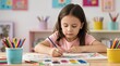© Budi - Cute little girl painting with watercolor and colored pencils at table in art classroom