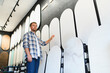 © Serhii - Man choosing decorative plaster samples in design studio