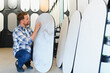 © Serhii - Man choosing decorative plaster finish for interior design
