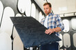 © Serhii - Man selecting decorative plaster panel for home renovation
