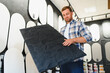 © Serhii - Man choosing decorative plaster panel for home renovation