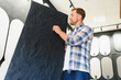 © Serhii - Customer choosing decorative plaster material in a home decor studio