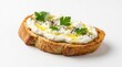 © Masque - Baguette sandwich with labneh, herbs, and olive oil on a white background.