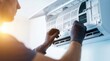 © Lamduan - Copy space for text featuring a professional technician inspecting and replacing air conditioning filters