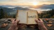 © pakawan - Amidst a tranquil mountain sunrise, human hands hold an open book with fearless text as a symbol of courage and inspiration