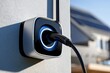 © SiyamBin - An electric vehicle charging station mounted on a wall glows with blue light during the day. This modern EV infrastructure concept supports sustainable transportation and green.