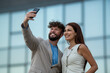 © Zoran Jesic - Business partners smiling taking selfie with smartphone outdoors